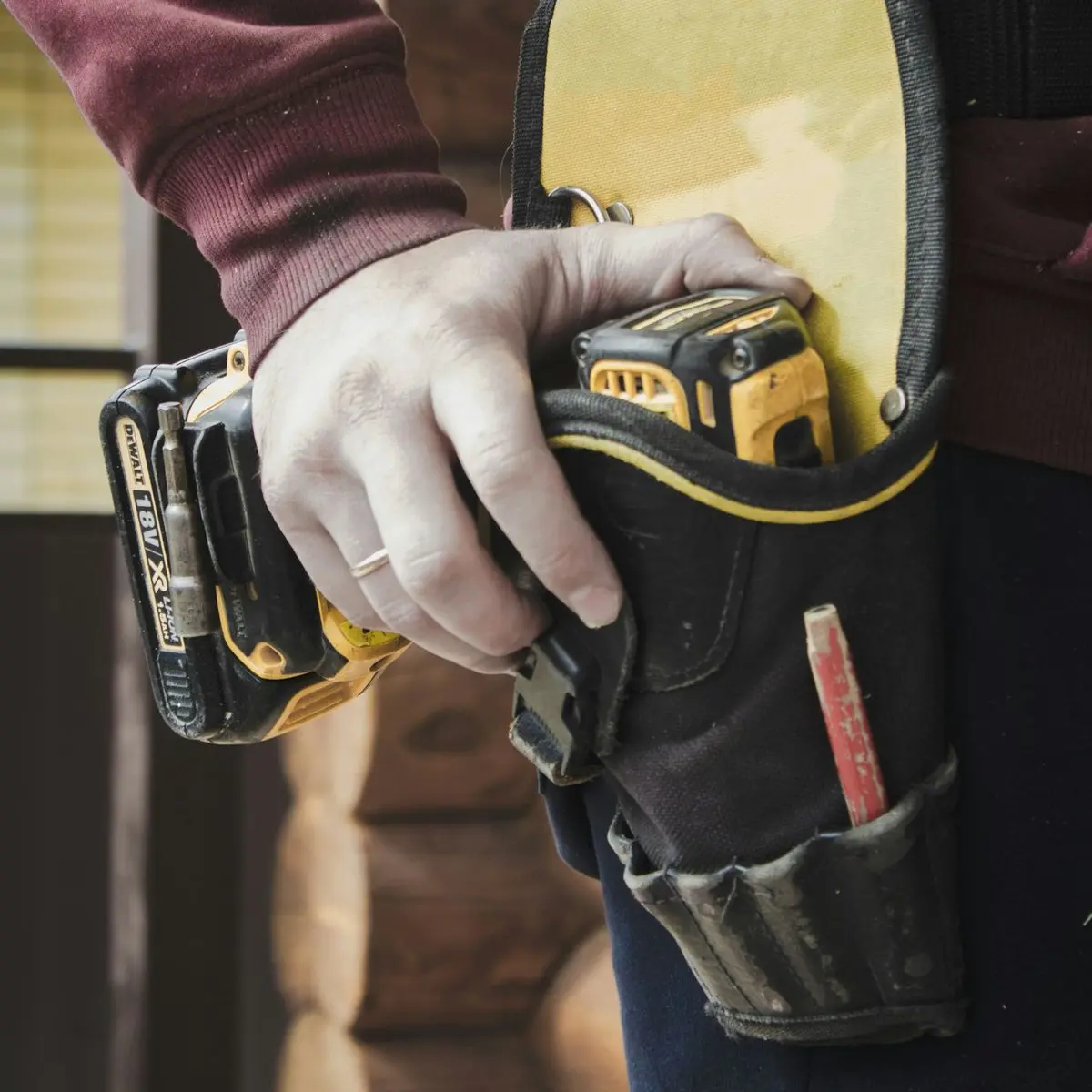 person holding black and yellow nike gloves